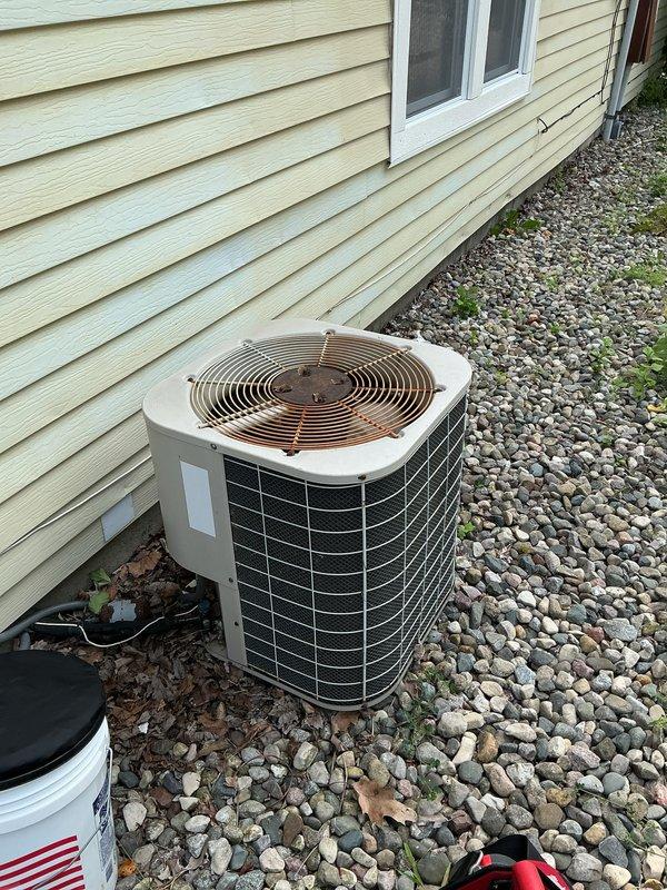 Responded to service call for 15-year-old central air conditioning system with reported compressor issues. Upon arrival, performed comprehensive inspection of outdoor condenser unit and electrical disconnect box. Inspected condenser unit exterior condition, fan assembly, and grille components. Opened and examined electrical disconnect enclosure, finding aged wiring connections with visible weathering and debris accumulation at terminals. Evaluated wire connections including line and load side terminals showing signs of outdoor exposure over time. Additionally performed requested furnace maintenance on 16-year-old heating system as customer requested combined service visit. System remained operational for both heating and cooling functions throughout service appointment.