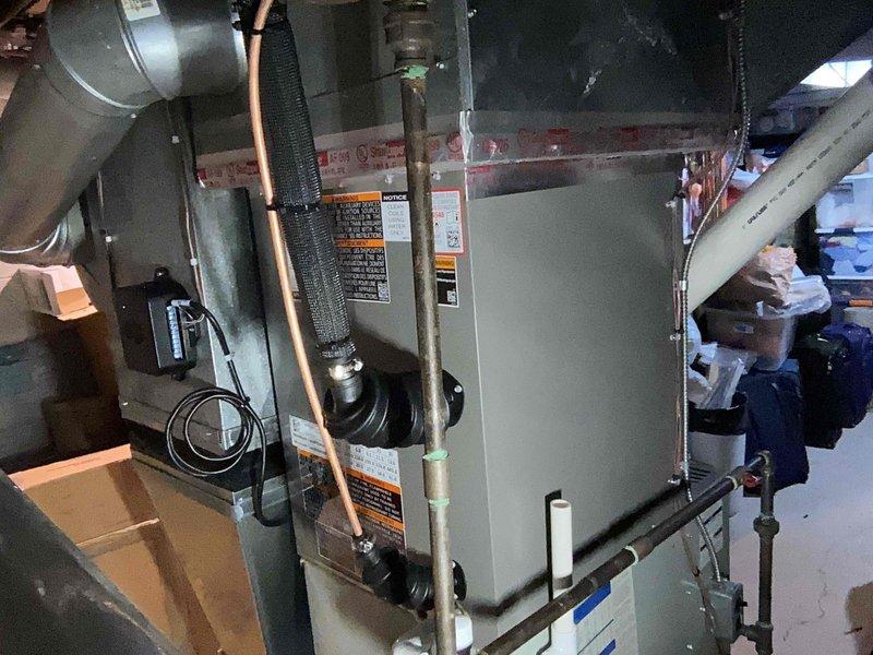 Completed installation of 3-ton air conditioning system with evaporator coil in basement utility area. Connected refrigerant lines to existing furnace, installed copper piping with proper insulation, and integrated all ductwork connections. Verified all electrical connections, tested system operation, and ensured proper airflow through newly installed components.