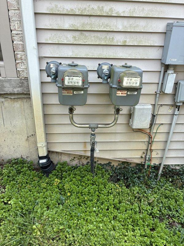 Completed electrical estimate for new whole home generator installation at a manufactured home. Assessed existing electrical infrastructure including main service panel located in basement utility area and exterior dual meter configuration with weathered utility connections. Provided comprehensive quote for generator installation requirements including necessary electrical upgrades, transfer switch integration, and proper load calculations to support whole home backup power system.