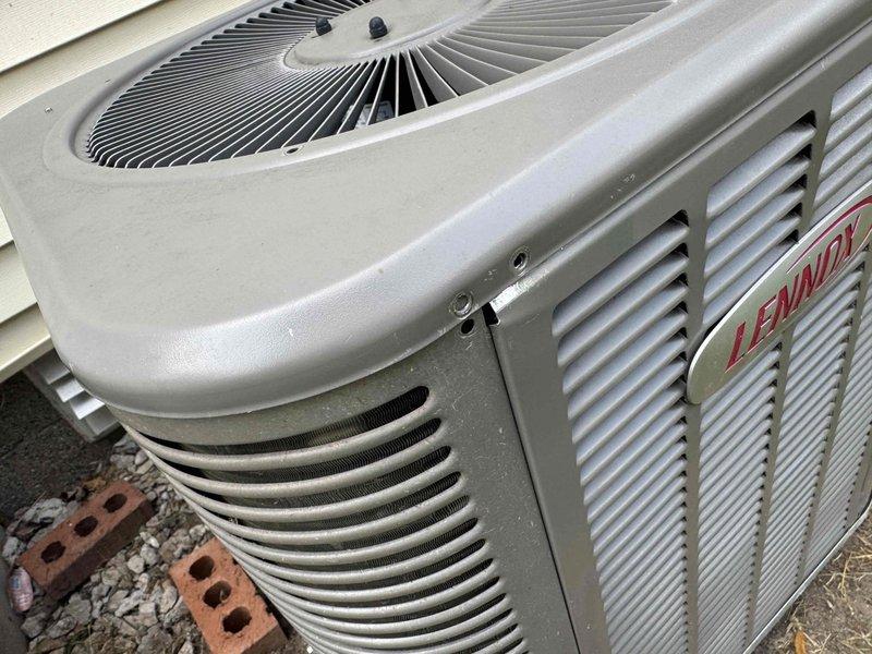 Responded to service call for Lennox air conditioning unit with non-operational condenser fan while compressor was running. Performed diagnostic inspection on 5-year-old basement-located system and identified failed fan motor. Replaced defective condenser fan motor and verified proper operation of unit with adequate airflow through coil. System restored to full cooling capacity with parts covered under warranty.