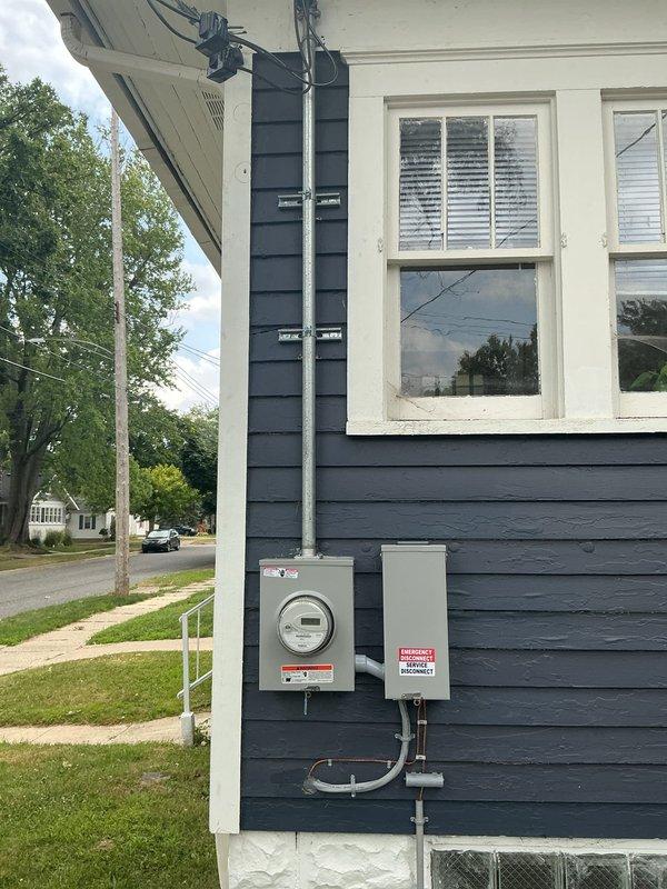 Completed electrical service panel installation on residential property in coordination with utility work request and permit PE26-0802. Installed new meter base and service panel on exterior wall with appropriate conduit runs and HVAC disconnect, ensuring all work met code requirements for scheduled municipal electrical inspection.
