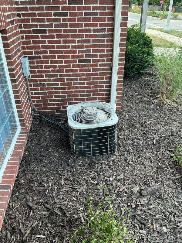 Performed comprehensive diagnostic evaluation on approximately 20-year-old Bryant residential cooling system for new homeowner experiencing unspecified operational concerns. Inspected outdoor condenser unit positioned against building exterior, noting unit condition and surrounding clearances adequate despite age. Verified electrical connections at outdoor unit including conduit routing and power supply integrity. Assessed indoor furnace and air handler components in mechanical room, examining ductwork connections, plenum assembly, and airflow pathways. System demonstrated continued cooling capacity during evaluation, though age-related wear consistent with two-decade operation timeline was evident throughout equipment inspection.