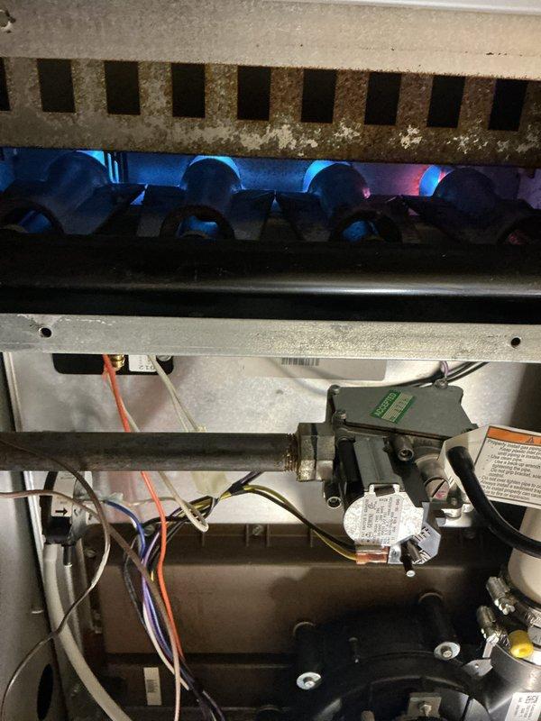 Completed comprehensive tune-up maintenance on both heating and cooling systems. Performed full system inspection, confirmed proper operation of gas furnace with burner assembly showing active combustion and appropriate flame characteristics. Replaced furnace air filter as requested. Verified all mechanical and electrical components functioning correctly, including blower motor, gas valve assembly, and control systems. Both HVAC units operating within normal parameters with no issues identified.