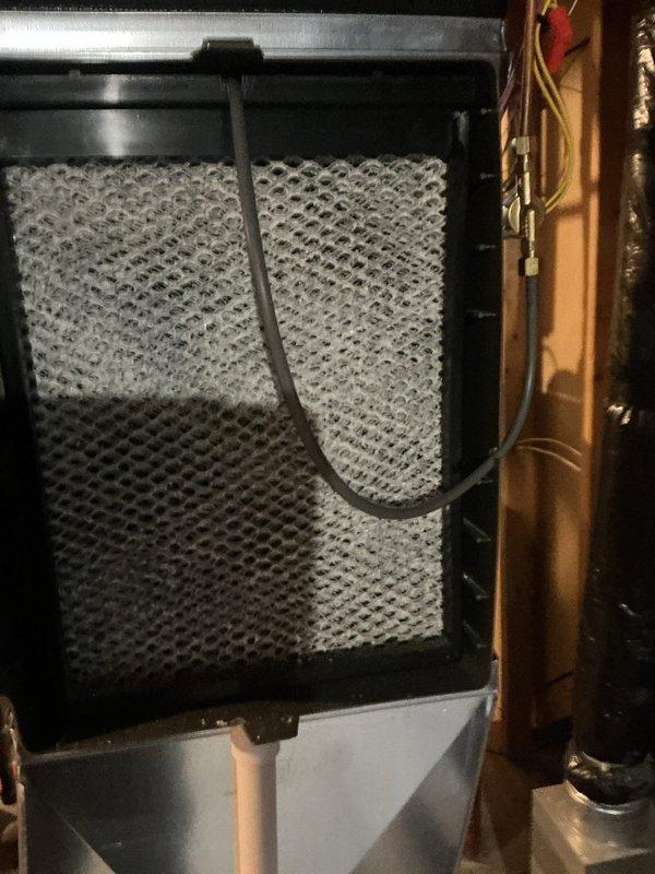Completed scheduled ComfortGuard maintenance package focusing on air filtration system components. Replaced evaporator coil filter media and humidifier pad as requested, inspecting the honeycomb mesh filter assembly and internal HVAC components for proper operation. All electrical connections, blower motor, and control board were verified to be in good working condition during the service visit.