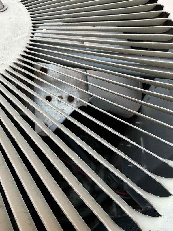 Responded to service call for outdoor AC unit making unusual noise with non-operational condenser fan. Upon arrival, inspected unit and found significant debris accumulation including leaves and organic matter obstructing fan operation and restricting airflow through condenser coil. Removed accumulated debris from unit interior and base, cleared ventilation pathways, and verified fan motor could spin freely. Confirmed unit returned to normal operation with proper airflow, no abnormal sounds, and appropriate cooling performance.