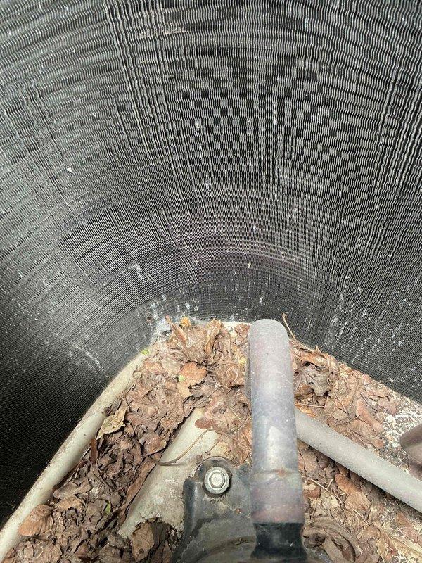 Responded to service call for outdoor AC unit making unusual noise with non-operational condenser fan. Upon arrival, inspected unit and found significant debris accumulation including leaves and organic matter obstructing fan operation and restricting airflow through condenser coil. Removed accumulated debris from unit interior and base, cleared ventilation pathways, and verified fan motor could spin freely. Confirmed unit returned to normal operation with proper airflow, no abnormal sounds, and appropriate cooling performance.