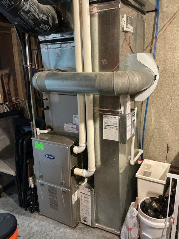 Completed annual cooling maintenance on Carrier HVAC system. Inspected indoor furnace unit and outdoor condenser, changed air filter, cleaned condenser coil and pad, verified proper system operation and airflow throughout equipment.