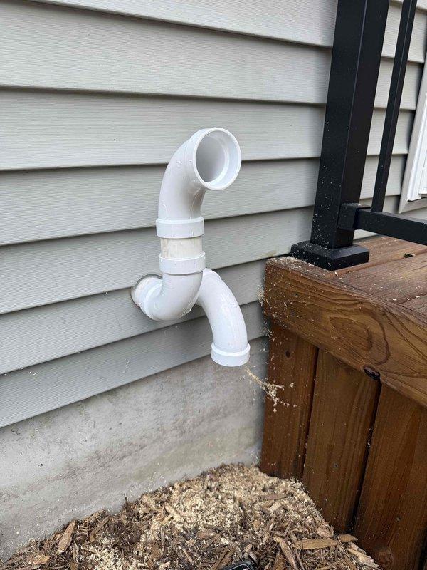 Completed full HVAC system installation including a 70,000 BTU furnace and 2-ton air conditioning unit in basement utility area with exterior condenser placement in rear yard. Installation included white PVC venting system routed through exterior wall with proper termination elbows, humidifier integration with furnace unit, and reconnection of all ductwork including flexible and rigid metal ducting. System was fully commissioned with proper condensate drainage, gas line connections, and electrical hookup to ensure operational readiness.