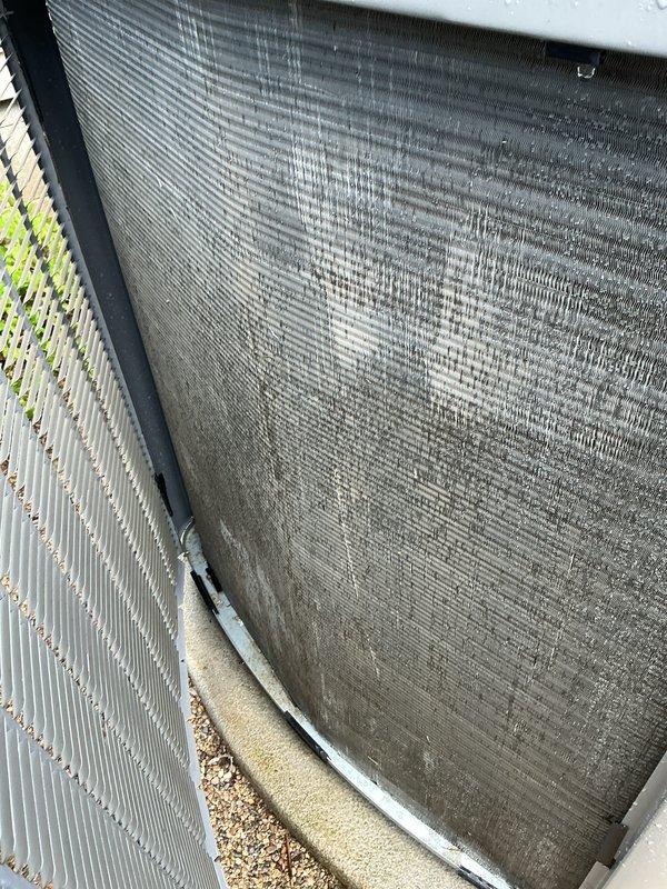 Completed annual cooling maintenance on Lennox CX35-18/24B-6F-20 air handler and outdoor condensing unit. Inspected indoor unit, verified manufacturer specifications and refrigerant data on equipment label, and documented system information. Performed exterior condenser maintenance, noting heavily soiled mesh screen with significant dirt and debris accumulation requiring attention, while condenser coil fins remained clean. Replaced air filter as part of routine preventive maintenance protocol.