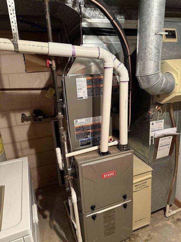 Successfully installed a 2.5-ton Bryant air conditioning system with matching evaporator coil in residential basement utility space. Installation included connecting copper refrigerant lines to existing furnace system, routing PVC condensate drainage lines, integrating new coil unit with existing ductwork, and completing all electrical connections. System was installed per manufacturer specifications with proper refrigerant line configuration and secured to right-side positioning as specified in permit requirements.