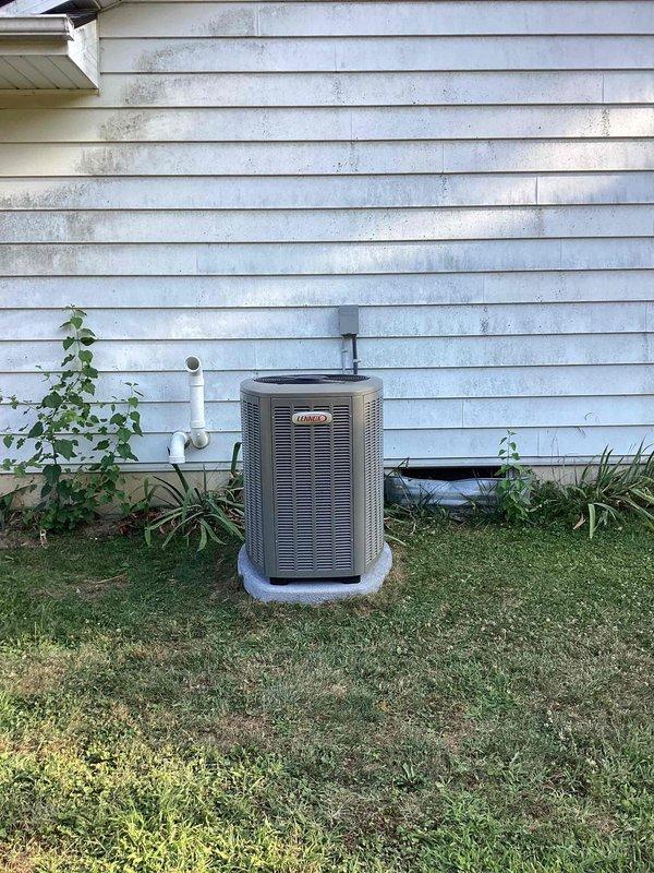 Completed full HVAC system installation including a 90,000 BTU furnace with humidifier and 3.5-ton air conditioning unit with rear discharge configuration. Installed new furnace in basement utility area with PVC venting routed through ceiling joists, connected metal ductwork and plenum assembly, and positioned Lennox condenser unit on concrete pad against exterior wall with proper refrigerant line connections. All mechanical permits were obtained prior to installation, system was tested and commissioned, and existing electrical connections were reconnected to ensure proper operation of both heating and cooling components.