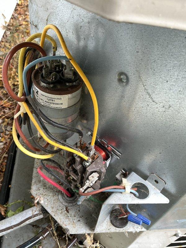 Completed routine air conditioner maintenance under spray maintenance program on a fifteen-year-old system that was operating properly at time of service. Performed comprehensive AC tune-up including inspection of outdoor condenser unit, electrical components, capacitor, and wiring connections. All components found to be in functional condition with typical outdoor weathering present on housing and panels.