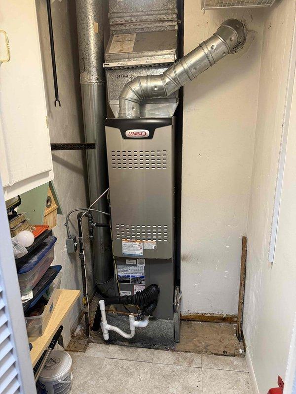 Completed full HVAC system installation including a Lennox 70,000 BTU furnace, 2-ton air conditioning unit, and evaporator coil in residential utility space. Installed all necessary ductwork connections, PVC condensate drainage piping, and electrical reconnections for rear-discharge configuration. All equipment installed per manufacturer specifications with proper ventilation and drainage systems in place.