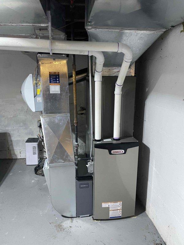 Completed full HVAC system installation in residential basement including Lennox 70,000 BTU furnace, 2-ton air conditioning unit with rear discharge configuration, evaporator coil, and humidifier. Installed all necessary ductwork connections with galvanized metal transitions and flexible insulated ducting, routed PVC condensate and vent piping from furnace to proper termination points, and secured all components with appropriate hangers and supports. Reconnected electrical service to new equipment, verified proper airflow through supply and return duct systems, tested all safety controls and limit switches, and confirmed system operation across heating and cooling modes.
