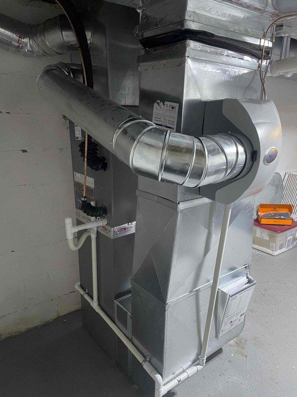 Completed full HVAC system installation in residential basement including Lennox 70,000 BTU furnace, 2-ton air conditioning unit with rear discharge configuration, evaporator coil, and humidifier. Installed all necessary ductwork connections with galvanized metal transitions and flexible insulated ducting, routed PVC condensate and vent piping from furnace to proper termination points, and secured all components with appropriate hangers and supports. Reconnected electrical service to new equipment, verified proper airflow through supply and return duct systems, tested all safety controls and limit switches, and confirmed system operation across heating and cooling modes.