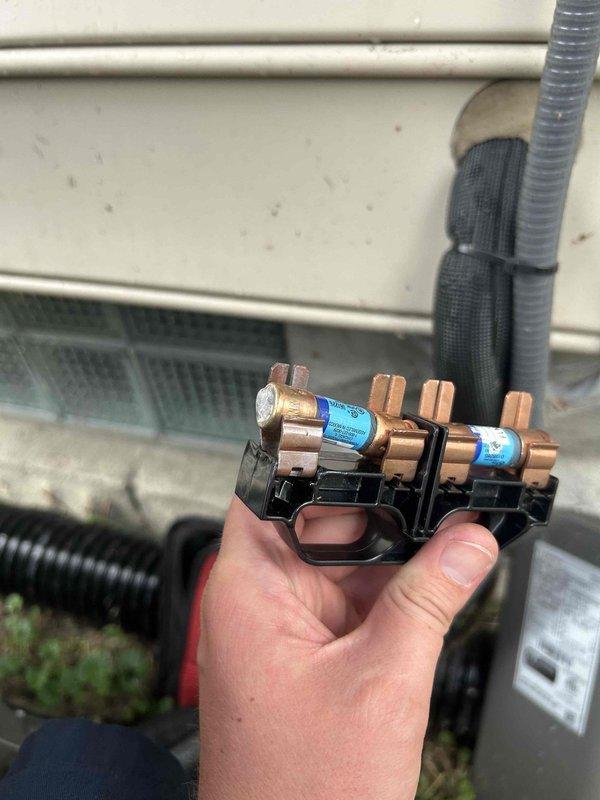 Responded to callback for 2-year-old AC unit with outdoor fan not operating and inadequate cooling. Upon inspection, discovered blown fuses in exterior disconnect box, as indicated by illuminated fault indicators. Replaced defective reversing valve solenoid, which had failed and contributed to system malfunction. Installed new fuses, tested disconnect switch operation, and verified proper electrical connections. Cycled system through complete operational test, confirmed outdoor fan motor engagement, verified adequate airflow, and validated proper cooling performance across all system functions.