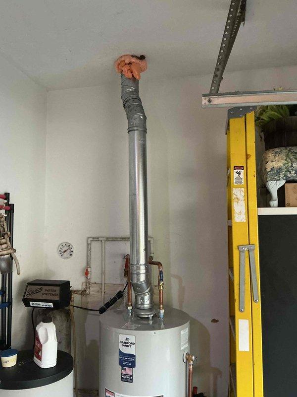 Completed full HVAC system installation including a 70,000 BTU furnace with evaporator coil and a 2-ton air conditioning condenser unit positioned on rear concrete pad. Installed new condensing unit on exterior pad with proper refrigerant line connections, electrical disconnect box, and all necessary fittings and valves. Furnace and coil installed in utility area with proper venting through existing ductwork. All refrigerant lines properly insulated and secured to building exterior. System tested for proper operation, airflow, and refrigerant charge. Electrical connections verified and secured at disconnect box. All mechanical permits obtained prior to installation.