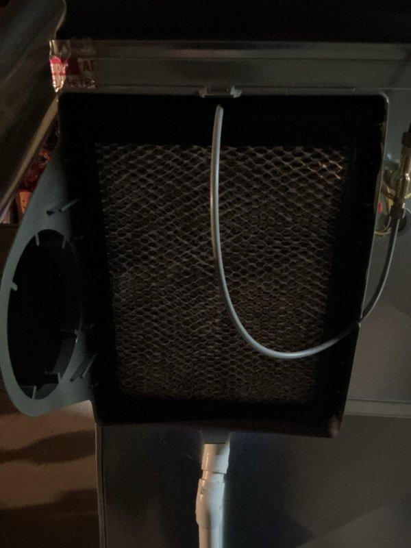 Completed annual HVAC maintenance on air handler unit, including inspection of blower assembly and cabinet condition noting rust staining on upper housing. Replaced dirty pleated air filter with accumulated debris to restore proper airflow and system efficiency.