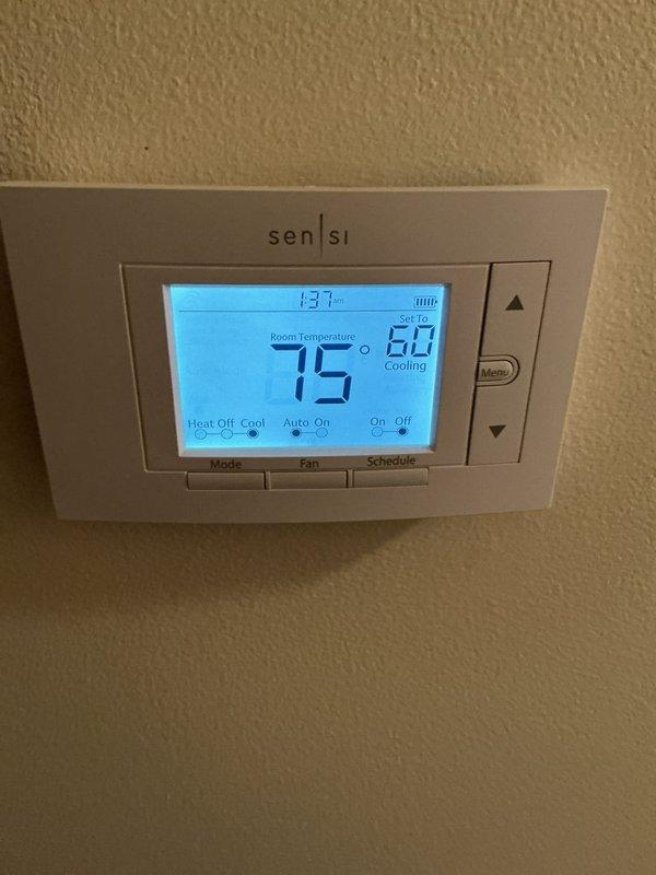 Completed annual cooling maintenance on residential HVAC system. Performed comprehensive inspection of air handler unit, verified proper operation of refrigerant lines and connections, checked thermostat functionality showing system cooling to setpoint of 60°F with current temperature reading of 75°F. Replaced air filter and evaporator pad as scheduled maintenance items.