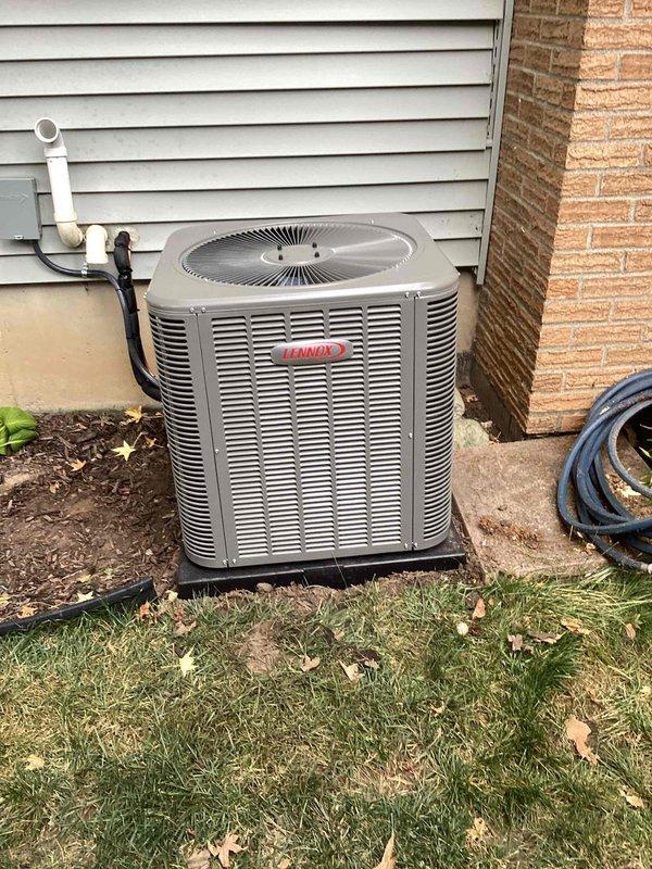 Completed installation of 3-ton Lennox air conditioning condenser unit and matching evaporator coil at residential property. Outdoor condenser positioned on pad against exterior wall with proper clearances, connected via refrigerant lines and electrical supply. Indoor evaporator coil installed in air handler system with PVC condensate drainage piping routed through basement utility area, secured with proper mounting brackets and including necessary P-trap configuration. All refrigerant lines insulated and secured, electrical connections completed to code specifications. System tested for proper operation, refrigerant charge verified, and airflow confirmed. Installation performed under mechanical permit for left-side placement with reconnection to existing ductwork and electrical infrastructure.