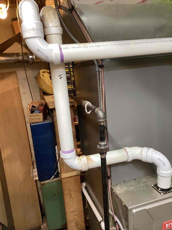 Completed installation of 3-ton Lennox air conditioning condenser unit and matching evaporator coil at residential property. Outdoor condenser positioned on pad against exterior wall with proper clearances, connected via refrigerant lines and electrical supply. Indoor evaporator coil installed in air handler system with PVC condensate drainage piping routed through basement utility area, secured with proper mounting brackets and including necessary P-trap configuration. All refrigerant lines insulated and secured, electrical connections completed to code specifications. System tested for proper operation, refrigerant charge verified, and airflow confirmed. Installation performed under mechanical permit for left-side placement with reconnection to existing ductwork and electrical infrastructure.