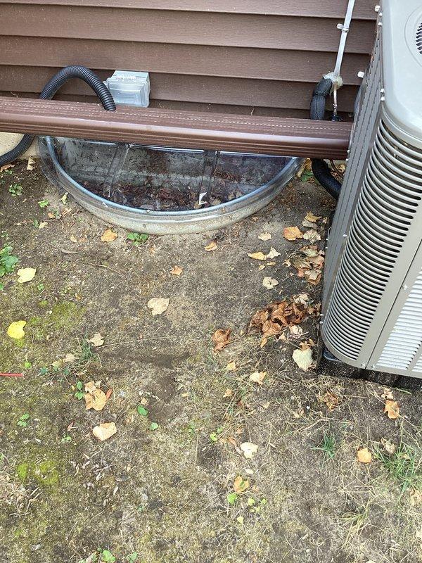 Completed installation of a 2-ton air conditioning system with matching evaporator coil at residential property. Installed outdoor condensing unit on left side of home on existing concrete pad, ran refrigerant lines along exterior wall with proper mounting brackets, and established new dedicated electrical circuit to meet code requirements. Obtained mechanical and electrical permits prior to installation, and noted existing window well cover may require replacement during future service visit.