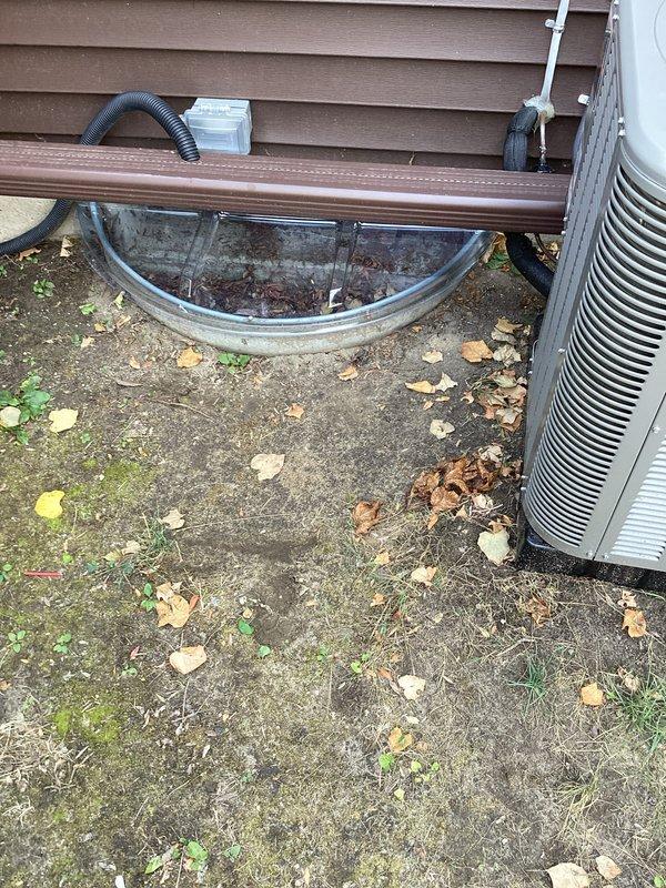Completed installation of a 2-ton air conditioning system with matching evaporator coil at residential property. Installed outdoor condensing unit on left side of home on existing concrete pad, ran refrigerant lines along exterior wall with proper mounting brackets, and established new dedicated electrical circuit to meet code requirements. Obtained mechanical and electrical permits prior to installation, and noted existing window well cover may require replacement during future service visit.