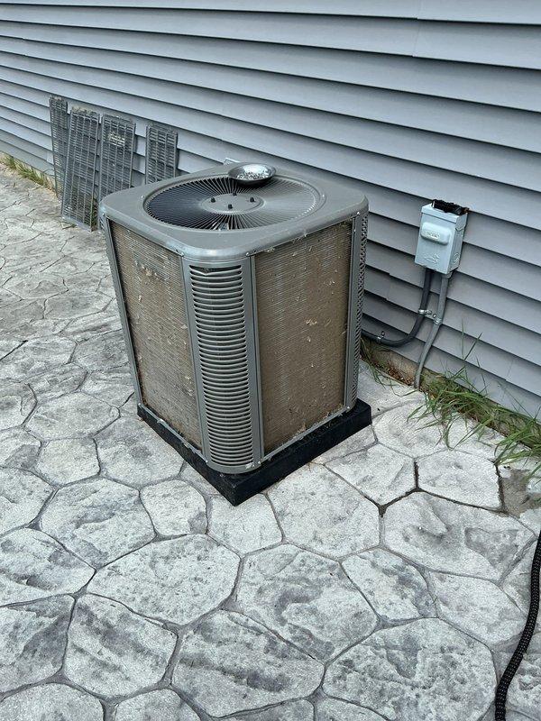 Completed comprehensive 5-year ComfortGuard maintenance service on residential outdoor air conditioning condenser unit. Performed thorough inspection of all system components including condenser coils, fan assembly, electrical connections, refrigerant lines, and disconnect box. Unit exterior showed normal weathering consistent with age, with condenser positioned on proper mounting pad with adequate clearance for airflow and serviceability. All safety controls and electrical connections were verified operational, and system components were found to be functioning within normal parameters for scheduled preventive maintenance protocol.