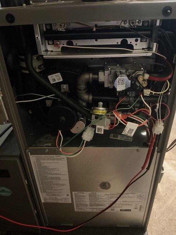 Completed annual preventative maintenance on one-year-old Lennox forced air furnace and air conditioning system. Performed comprehensive inspection of gas valve assembly, electrical connections, and internal components with all systems found operating within normal parameters. Documented equipment condition through photography showing proper installation, secure wiring connections (red, yellow, and white leads), and intact manufacturer specifications label with AHRI certification, with no deficiencies noted and both units confirmed in proper working order.