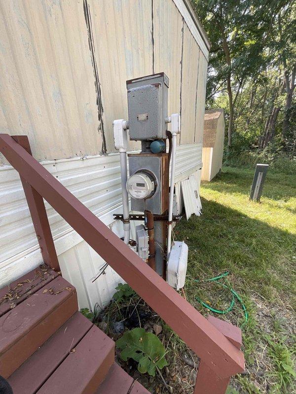 Completed estimate for furnace and air conditioning system replacement at residential property for new homeowner experiencing non-operational heating equipment. Assessed existing Miller furnace and water heater located in utility room, both of unknown age and currently not starting. Evaluated electrical service panel and exterior meter assembly, documented existing HVAC infrastructure, and provided comprehensive replacement options for both heating and cooling systems to restore climate control functionality to the home.
