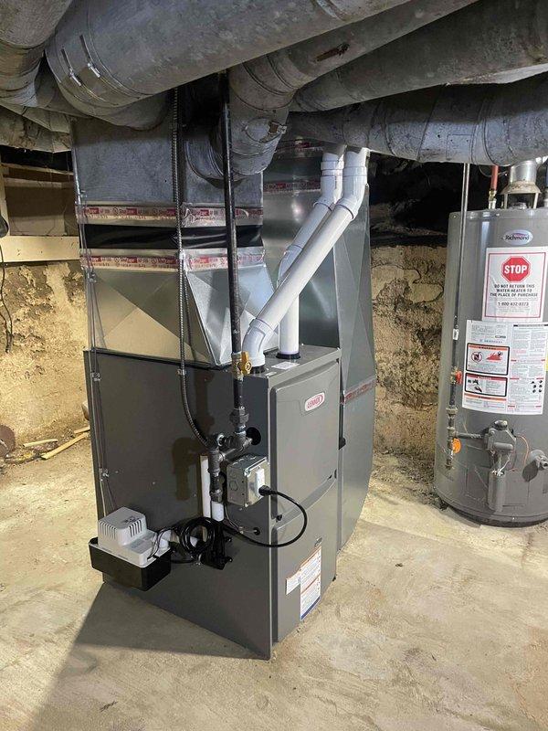 Completed installation of 70,000 BTU furnace unit in basement mechanical room with new PVC venting system routed through exterior wall. Connected condensate pump to furnace, integrated unit with existing ductwork, and reconnected gas supply line. All mechanical permits obtained, system tested and operational per manufacturer specifications.