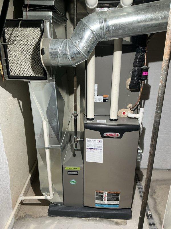 Completed comprehensive 5-year ComfortGuard maintenance on Lennox forced-air heating system. Performed full system inspection including furnace, ductwork, air filter housing, and digital thermostat operation. Investigated reported intermittent buzzing noise occurring during fan operation; inspected blower motor assembly, mounting hardware, and ductwork connections for loose components or vibration sources. Verified all PVC exhaust and intake vents properly secured, checked refrigerant line connections, and confirmed proper airflow through mesh filter housing. Tested thermostat functionality and system cycling; unit operating within normal parameters at time of service.