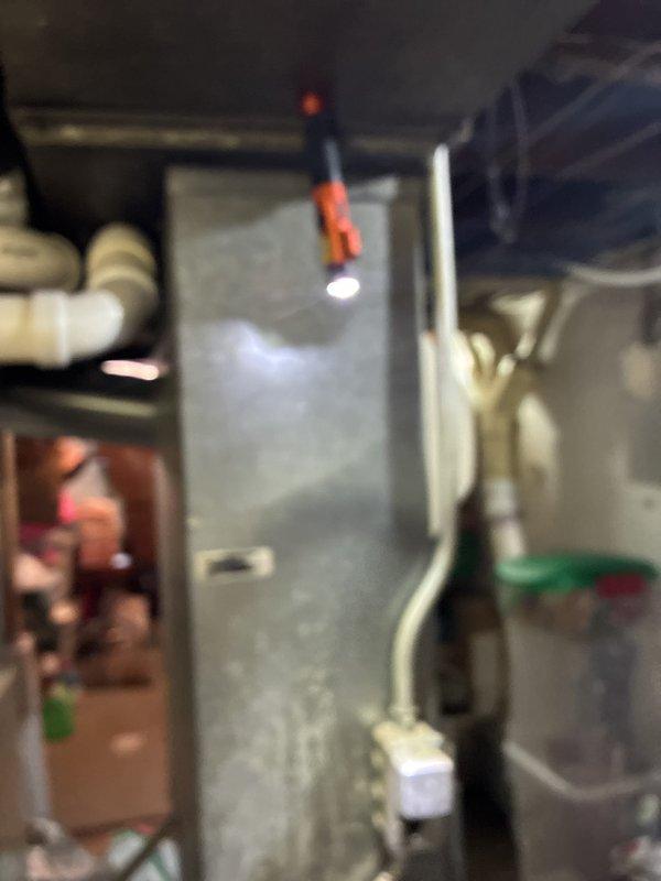 Provided replacement estimate for 23-year-old residential HVAC system consisting of 70,000 BTU natural gas furnace and 2.5-ton air conditioning unit located in basement. Current furnace operational but air conditioner not functioning. Assessed existing Lennox Elite Series furnace with PVC venting and adjacent air handler to determine replacement specifications and equipment requirements.