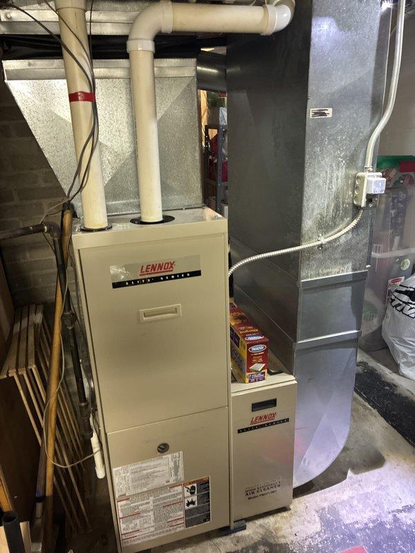 Provided replacement estimate for 23-year-old residential HVAC system consisting of 70,000 BTU natural gas furnace and 2.5-ton air conditioning unit located in basement. Current furnace operational but air conditioner not functioning. Assessed existing Lennox Elite Series furnace with PVC venting and adjacent air handler to determine replacement specifications and equipment requirements.