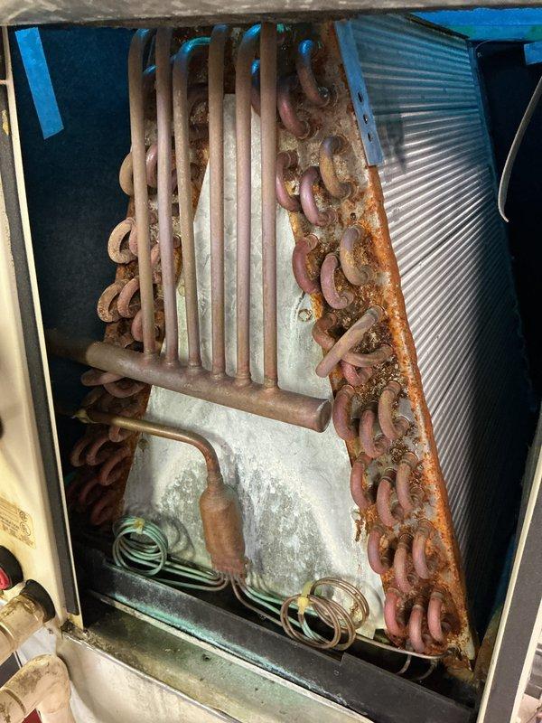 Completed annual preventive maintenance inspection on commercial refrigeration unit. During inspection, discovered severe corrosion throughout the evaporator coil assembly with extensive rust buildup on copper tubing and U-bends. Performed electrical diagnostics using digital multimeter to verify system operation and measured capacitance readings. Documented equipment condition with photographic evidence showing advanced deterioration of copper components and mineral deposits on fin assembly, recommending immediate coil replacement to prevent system failure.