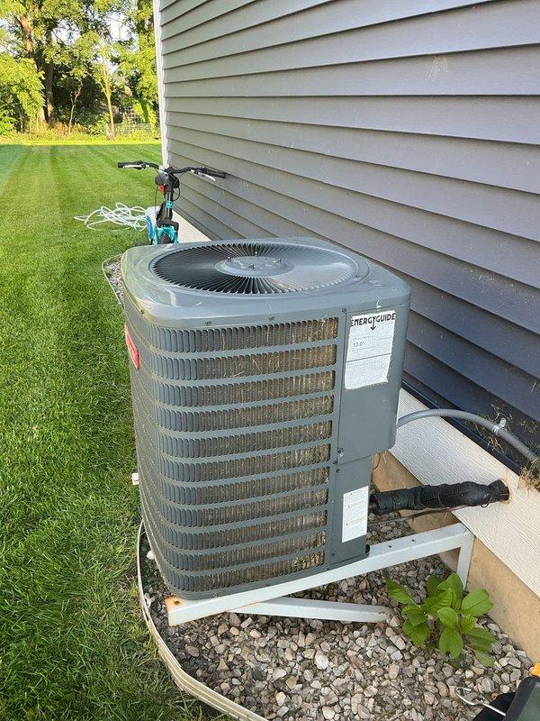 Completed annual cooling maintenance on Goodman outdoor condensing unit. Performed comprehensive system inspection including cleaning of condenser coils, checking refrigerant levels, testing electrical connections, and verifying proper operation of fan motor and compressor. Inspected condensate drain line for proper flow and cleared any blockages. Unit found to be operating within normal parameters with adequate airflow through louvers and grilles. Confirmed equipment is properly secured on pad with appropriate clearance from structure.