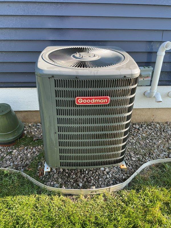 Completed annual cooling maintenance on Goodman outdoor condensing unit. Performed comprehensive system inspection including cleaning of condenser coils, checking refrigerant levels, testing electrical connections, and verifying proper operation of fan motor and compressor. Inspected condensate drain line for proper flow and cleared any blockages. Unit found to be operating within normal parameters with adequate airflow through louvers and grilles. Confirmed equipment is properly secured on pad with appropriate clearance from structure.