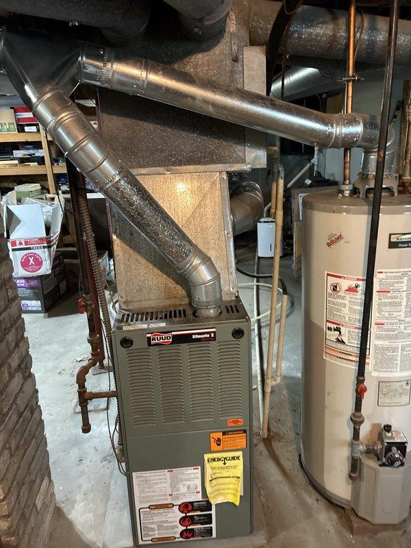 Conducted full system evaluation for HVAC replacement quote following previous maintenance visit that identified R22 refrigerant system operating below optimal charge levels. Assessed existing Ruud furnace and air conditioning system in basement mechanical room, documenting current equipment configuration including ductwork connections and clearances. Additionally evaluated existing water heater for replacement quote as requested, inspecting plumbing connections and venting requirements to provide comprehensive pricing for complete mechanical system upgrade.