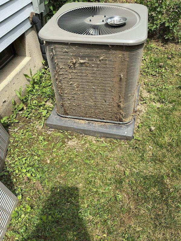 Completed annual cooling maintenance on residential air conditioning system. Inspected outdoor condenser unit, which showed heavy dirt and debris accumulation on exterior coils and fins, as well as vegetation growth encroaching around the base of the equipment. Cleaned condenser coils, cleared vegetation from around unit perimeter, and replaced air filter as needed to restore proper airflow and system efficiency.