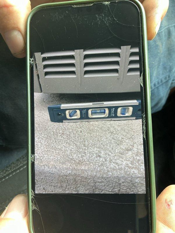 Responded to service call for 3-year-old Lennox A/C condenser unit with unstable platform mounting. Upon inspection, found outdoor condenser unit on concrete pad against exterior brick wall with significant leveling issues that compromised unit stability and posed risk of equipment falling. Used torpedo level to assess and verify pad alignment, then stabilized and secured condenser unit to platform, ensuring proper level positioning for safe operation and preventing potential damage to refrigerant lines and electrical connections. Unit now properly secured with both parts and labor under warranty coverage.