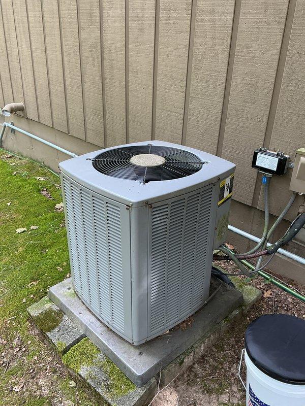 Completed annual preventive maintenance on 20-year-old Armstrong central air conditioning system. Performed comprehensive inspection of outdoor condenser unit, verified proper operation of compressor and condenser fan motor, checked refrigerant pressures and temperatures, inspected electrical connections and disconnect box, examined copper refrigerant lines and mounting brackets for secure installation and signs of wear. Cleaned condenser coils, verified unit level on concrete pad, tested capacitor values, and confirmed system cooling performance within manufacturer specifications. All components operating normally with no deficiencies noted at time of service.