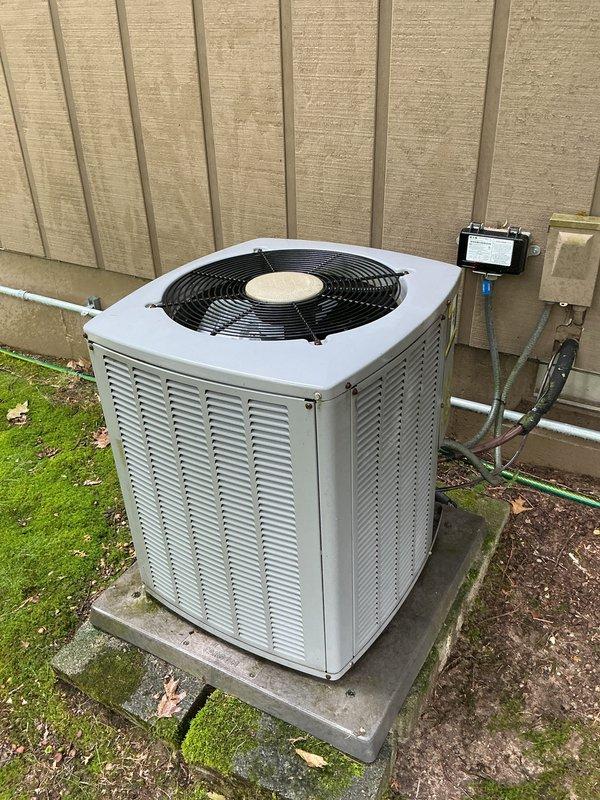 Completed annual preventive maintenance on 20-year-old Armstrong central air conditioning system. Performed comprehensive inspection of outdoor condenser unit, verified proper operation of compressor and condenser fan motor, checked refrigerant pressures and temperatures, inspected electrical connections and disconnect box, examined copper refrigerant lines and mounting brackets for secure installation and signs of wear. Cleaned condenser coils, verified unit level on concrete pad, tested capacitor values, and confirmed system cooling performance within manufacturer specifications. All components operating normally with no deficiencies noted at time of service.