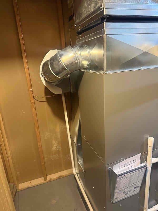 Completed full HVAC system installation including a 70,000 BTU furnace with humidifier and 2.5-ton air conditioning unit configured for right-side installation. Installed new furnace unit in mechanical room with metallic ductwork assembly, including 90-degree duct elbow connecting to existing ductwork system. Mounted and secured air handler unit against wall framing with proper clearances. Installed white PVC condensate drain and venting piping system on exterior wall with multiple elbow joints for proper drainage and exhaust ventilation. Reconnected all necessary electrical and mechanical connections to existing systems. Requested and coordinated mechanical permits for installation. All equipment properly installed, secured, and ready for operation per manufacturer specifications and local building codes.