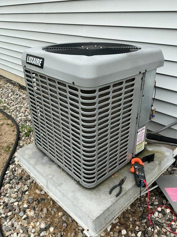 Completed scheduled air conditioning maintenance on Luxaire condensing unit. Performed system inspection, replaced air filter, and cleaned condenser pad. Unit operating within normal parameters with proper airflow through louvers and fan assembly functioning correctly.