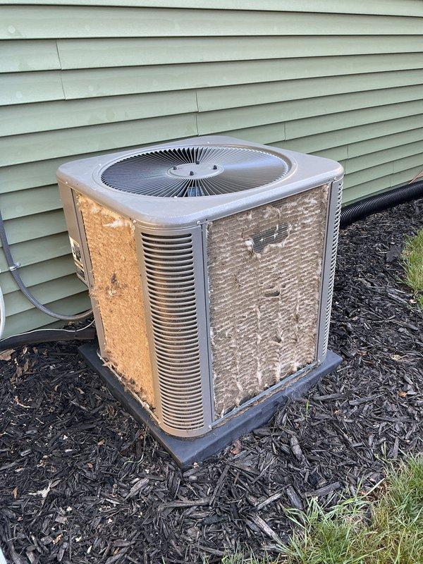 Completed annual cooling maintenance on residential outdoor condenser unit. Performed comprehensive system inspection, cleaned condenser coils, checked refrigerant levels, tested electrical connections, verified proper fan operation, and documented equipment condition with photos showing weathered exterior panels with visible rust and corrosion requiring monitoring for future replacement consideration.