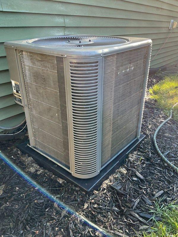 Completed annual cooling maintenance on residential outdoor condenser unit. Performed comprehensive system inspection, cleaned condenser coils, checked refrigerant levels, tested electrical connections, verified proper fan operation, and documented equipment condition with photos showing weathered exterior panels with visible rust and corrosion requiring monitoring for future replacement consideration.