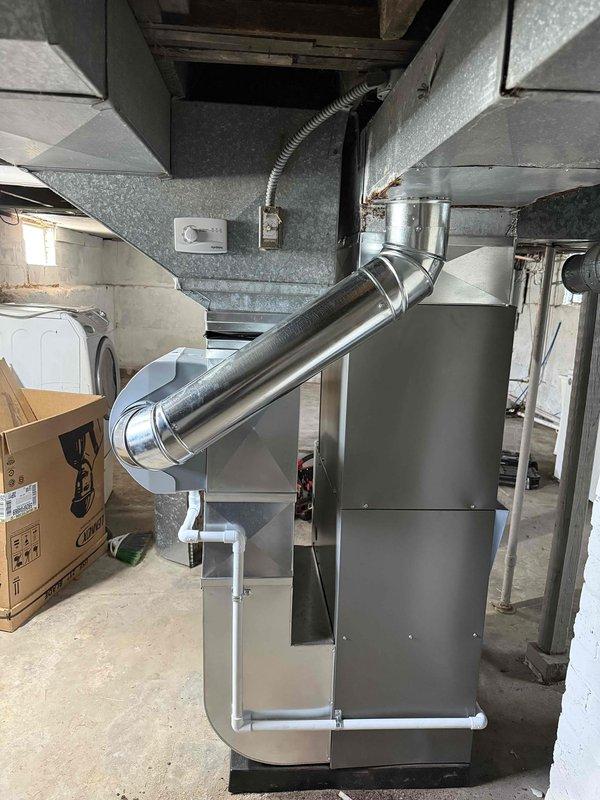 Completed full HVAC system installation including 70,000 BTU furnace with humidifier and 2.5-ton air conditioning unit. Installed Lennox outdoor condensing unit on rubber pad with proper refrigerant line routing and electrical disconnect. Indoor air handler positioned in basement with stainless steel venting, all ductwork connections completed. System installed per mechanical permit specifications with left-side configuration and existing electrical reconnection.