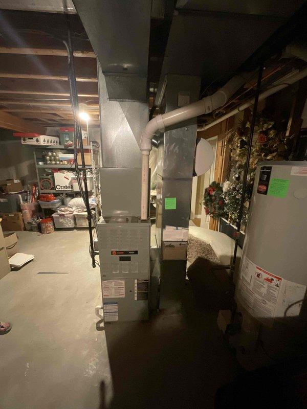 Provided comprehensive replacement estimate for 22-year-old basement HVAC system including natural gas furnace, central air conditioning unit, and water heater. Current furnace and water heater operational; air conditioning unit non-functional. Documented existing equipment configuration, ductwork layout, and installation conditions to prepare detailed replacement proposal for complete system upgrade.