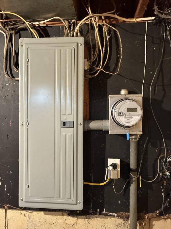 Completed estimate for replacement of 40-gallon electric water heater in basement utility area. Assessed existing installation including electrical panel, meter connections, and copper supply piping. Documented current water heater condition and surrounding mechanical room infrastructure for proposal preparation.