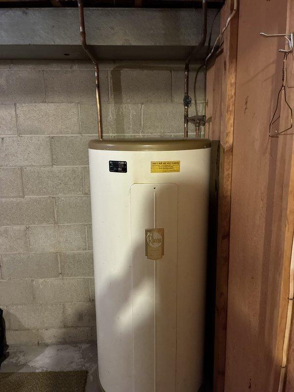 Completed estimate for replacement of 40-gallon electric water heater in basement utility area. Assessed existing installation including electrical panel, meter connections, and copper supply piping. Documented current water heater condition and surrounding mechanical room infrastructure for proposal preparation.
